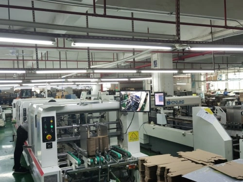 Automated packaging machinery processing paperboard box components